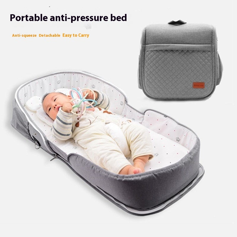HOMCOM newborn baby folding portable bed with soft padding and side rails, designed for safe and comfortable sleep for infants.