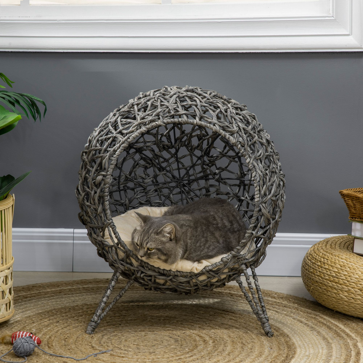 Silver-tone rattan elevated cat house with cushion, PawHut pet bed for kittens, featuring a cozy, stylish grey basket with soft interior.