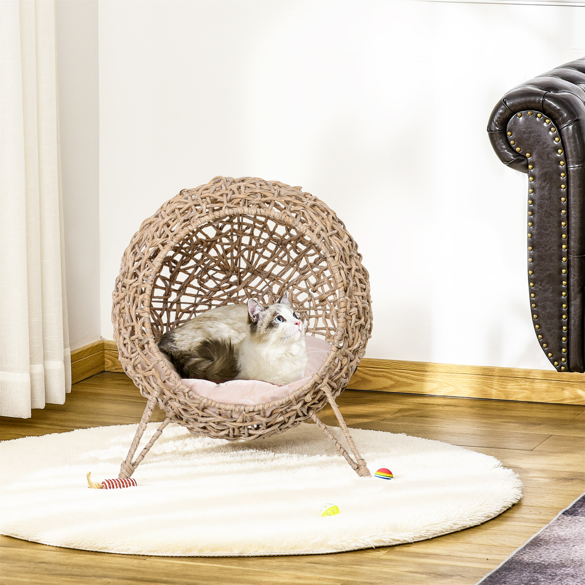 Ball-shaped rattan cat house with natural wood finish, raised feline bed, cozy and stylish for small cats or kittens.