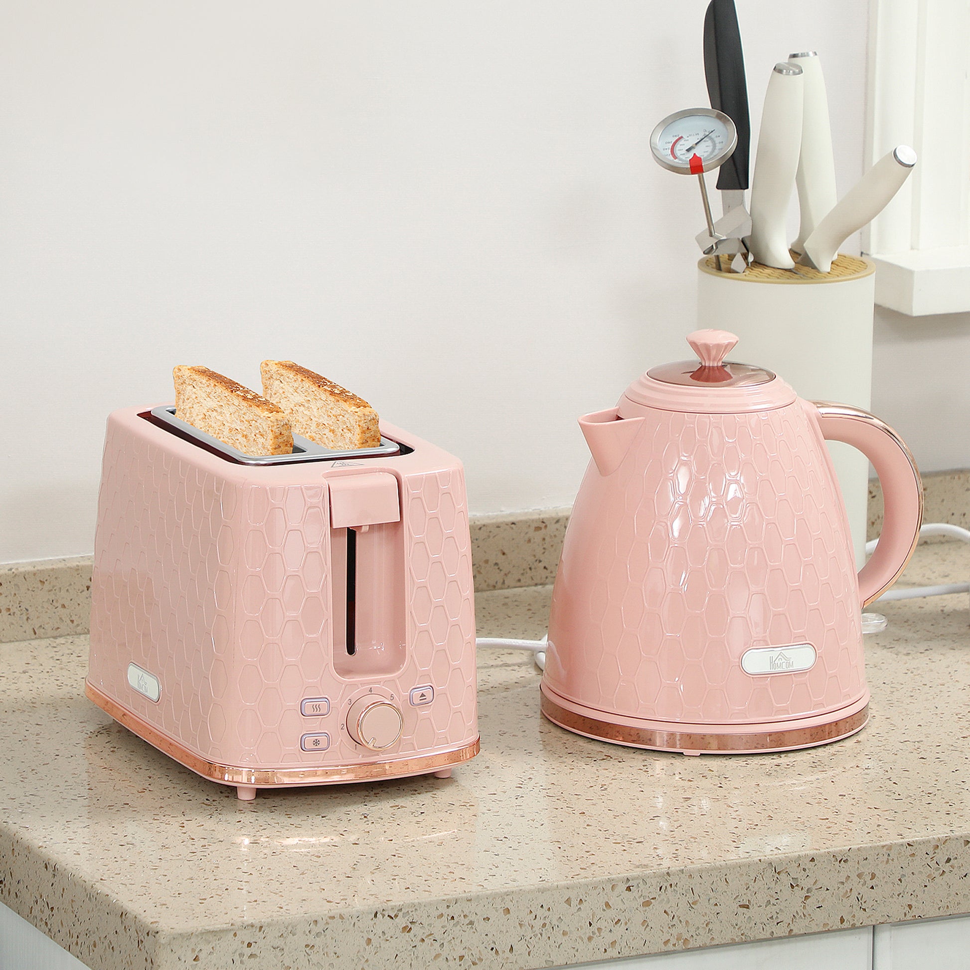HOMCOM pink 1.7L 3000W fast boil kettle and 2-slice toaster set with auto shut-off and browning controls, on a kitchen countertop.