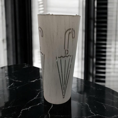 Cream metal umbrella stand, 49cm tall with a sleek design, featuring multiple compartments for organizing umbrellas.