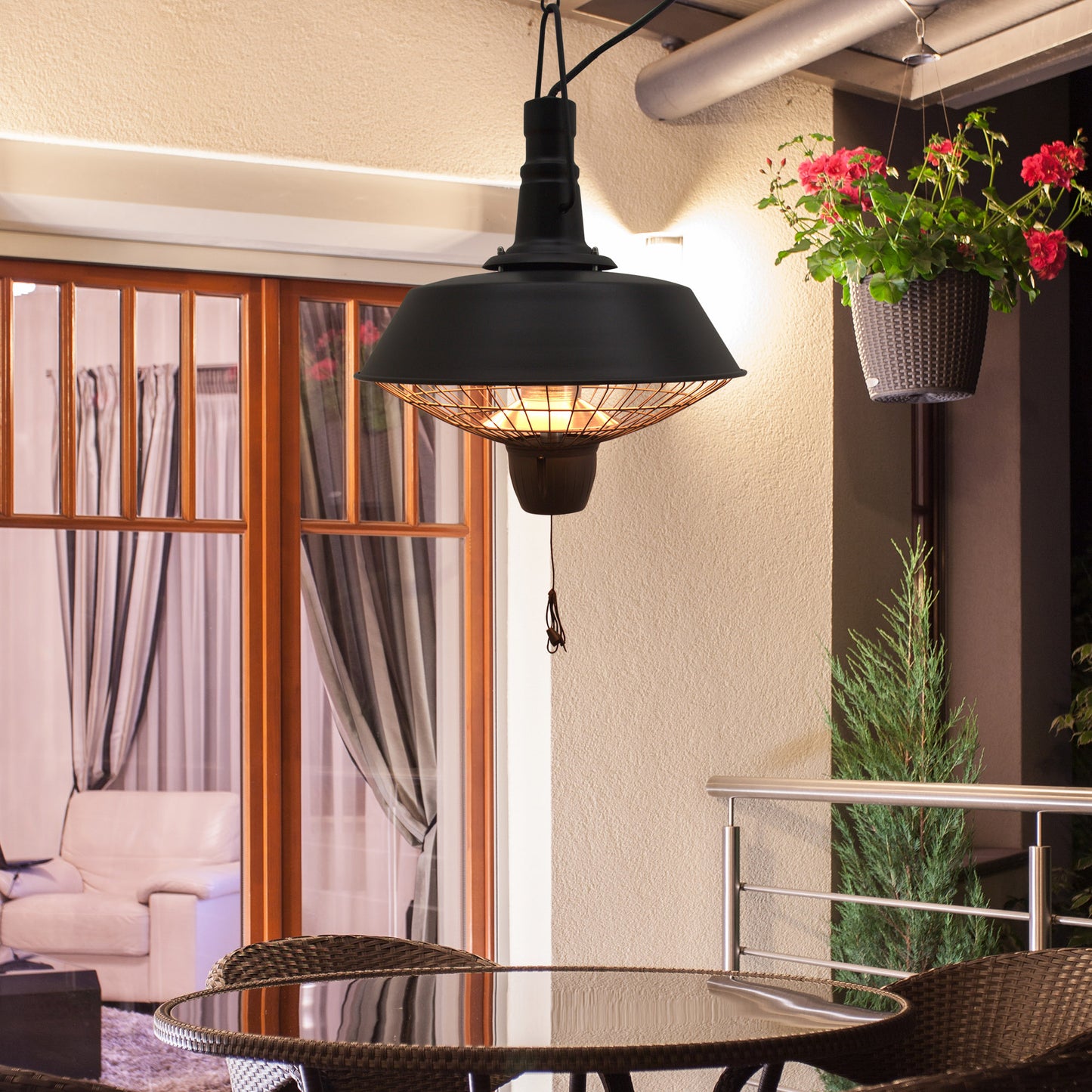 Black HOMCOM 2100W outdoor ceiling-mounted halogen electric patio heater hanging in a garden setting.
