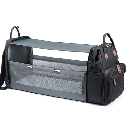 HOMCOM multifunctional portable folding crib mommy bag with storage compartments, showing its compact, foldable design and multiple pockets.
