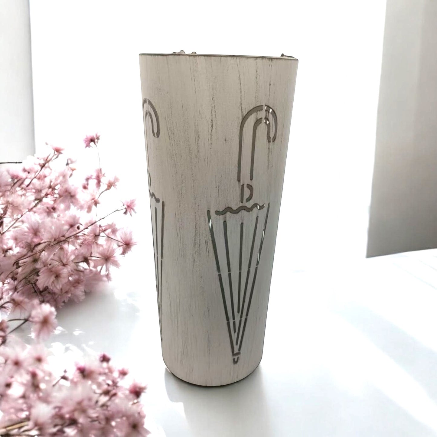 Cream metal umbrella stand, 49cm tall, with multiple compartments for organizing umbrellas, by MSL.