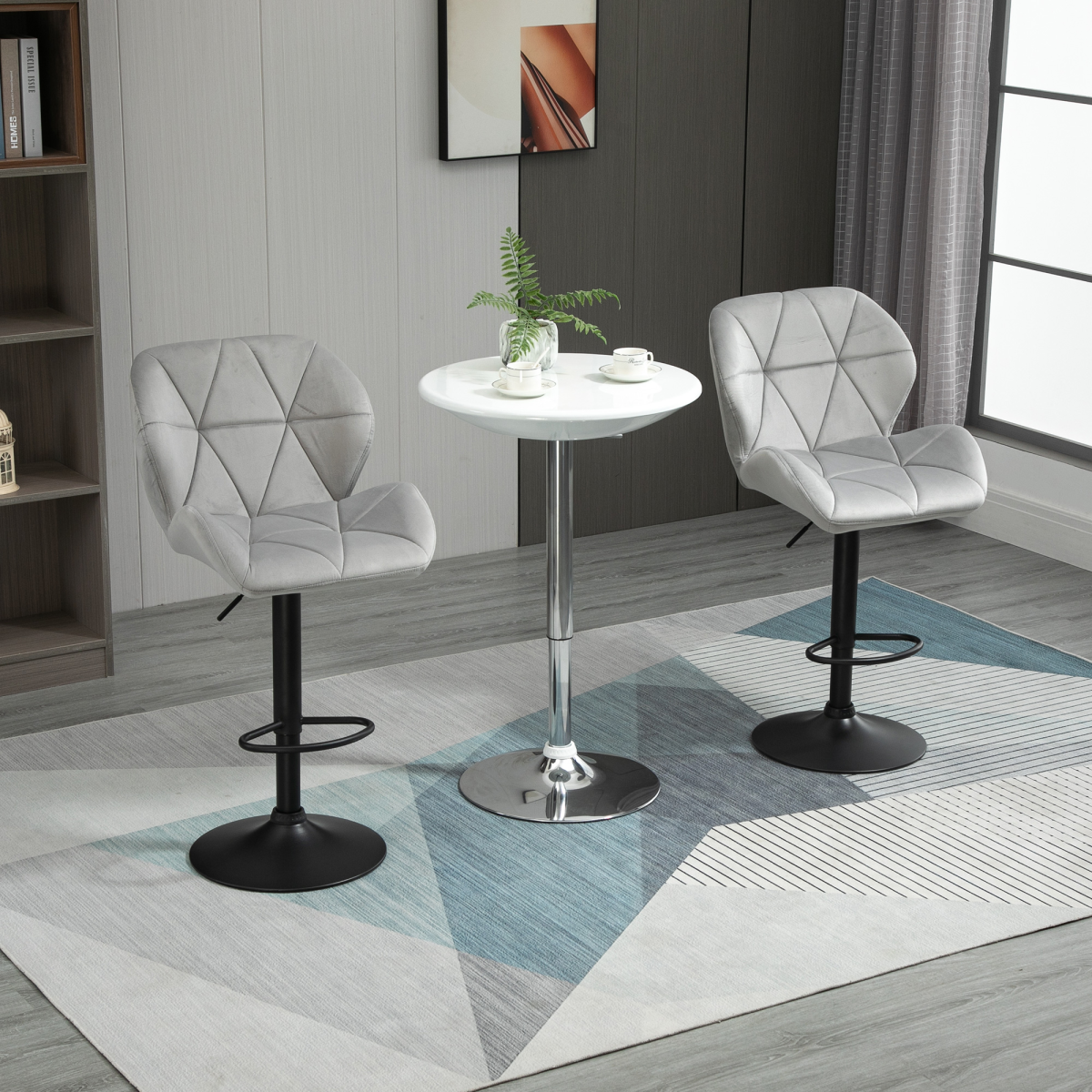 Set of two light grey fabric bar stools with adjustable height and metal bases, modern counter chairs for kitchen or bar area.