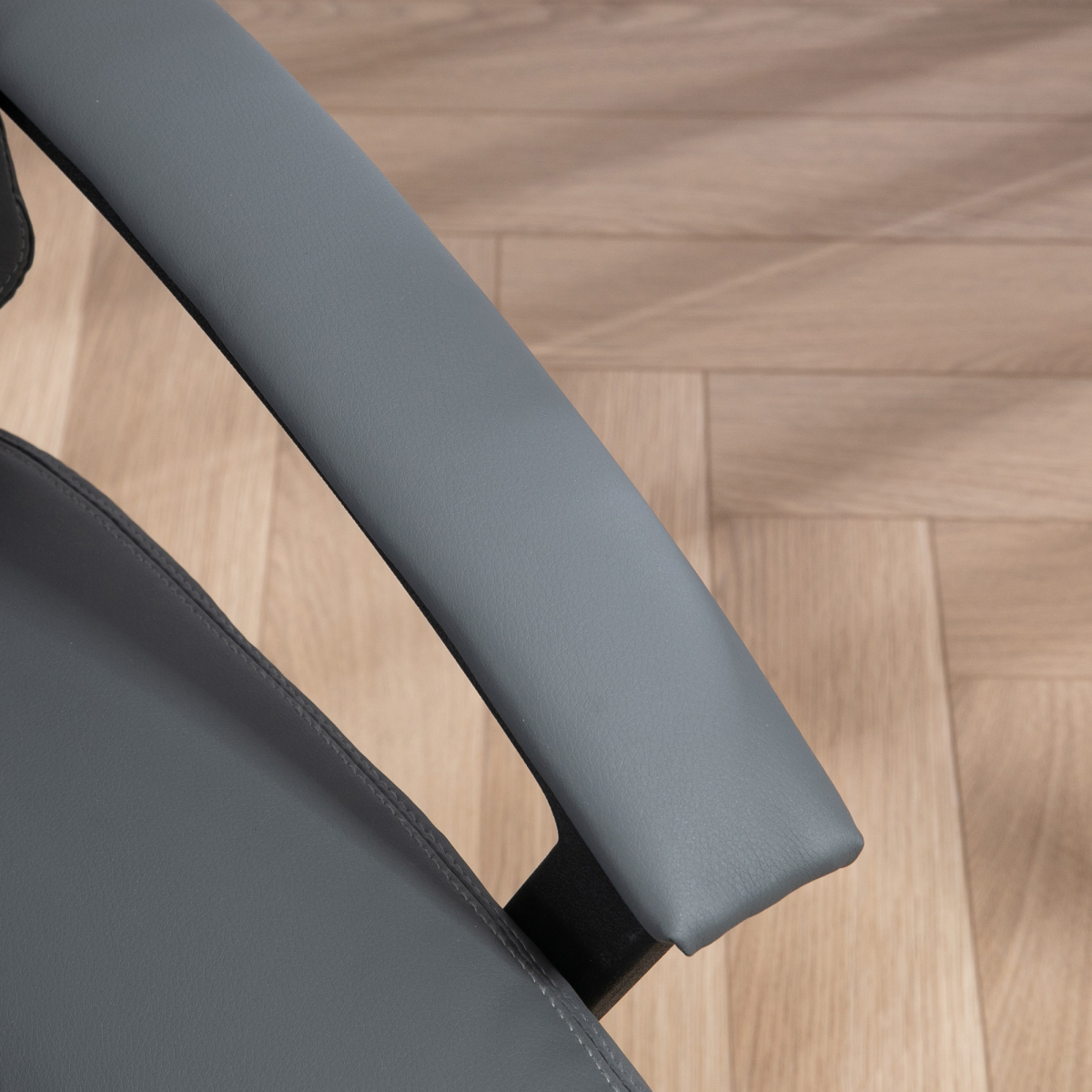 Dark grey HOMCOM faux leather mid-back home office chair with armrests, ergonomic design for comfortable desk seating.