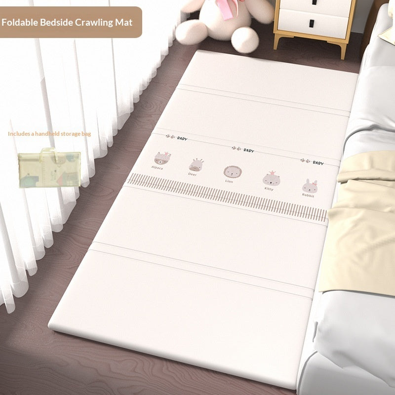 HOMCOM foldable baby crib side mat with soft padding, designed for protection in the living room, shown folded and laid beside a crib.
