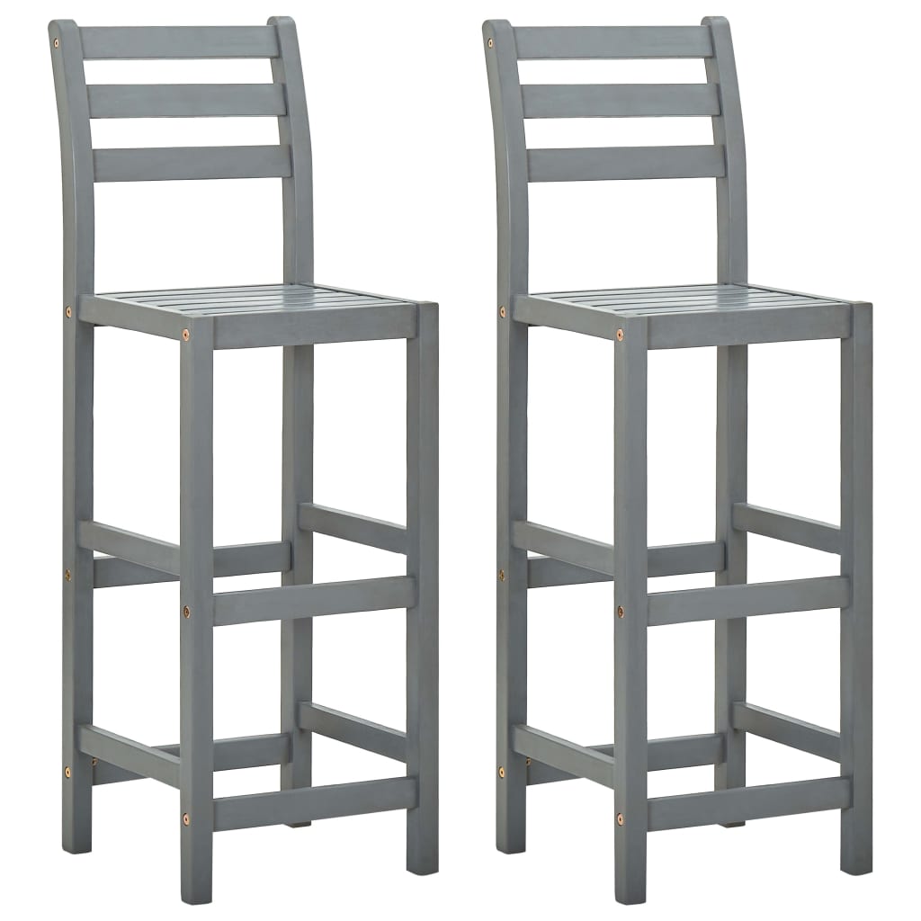 Two solid acacia wood bar chairs with a natural finish, featuring sturdy legs and backrests for a stylish kitchen or bar area.