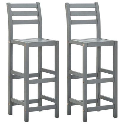 Two solid acacia wood bar chairs with a natural finish, featuring sturdy legs and backrests for a stylish kitchen or bar area.
