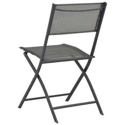 Pair of vidaXL folding outdoor chairs with steel frames and Textilene fabric, shown in a relaxed outdoor setting.
