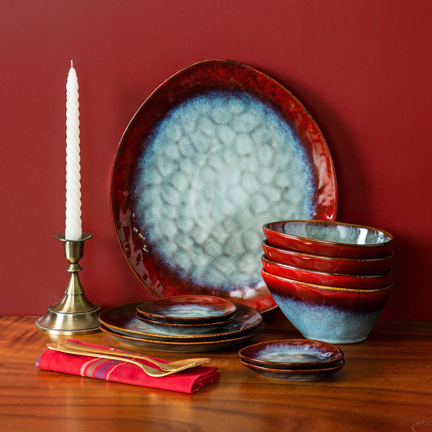 Starry Red ceramic dinnerware set by Livoshop including serving platter, dessert plates, bowls, and saucers with vintage look