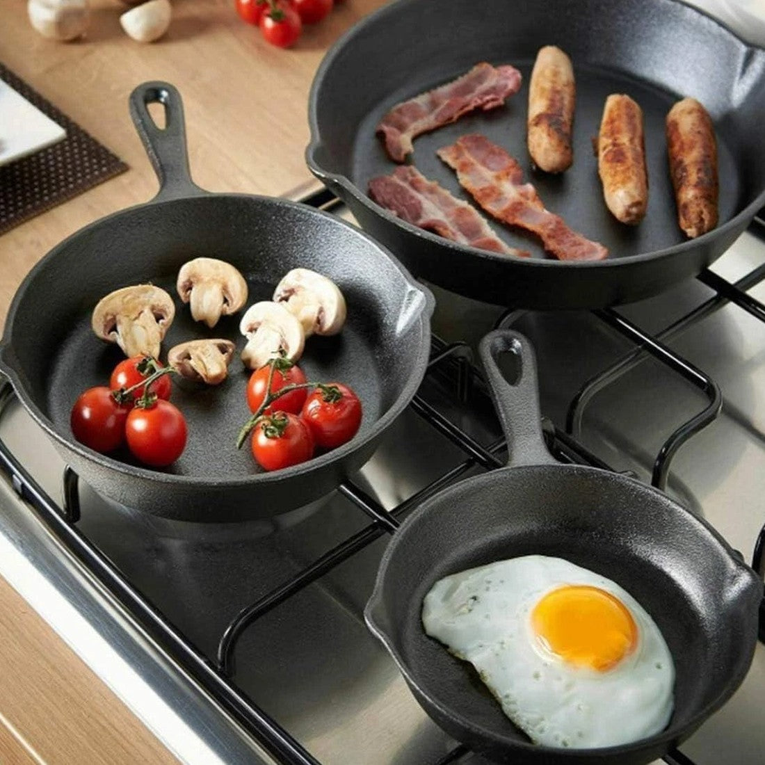 Three HOMCOM cast iron non-stick skillet griddles with seasoned surface, ideal for frying and cooking in a durable, versatile pan set.
