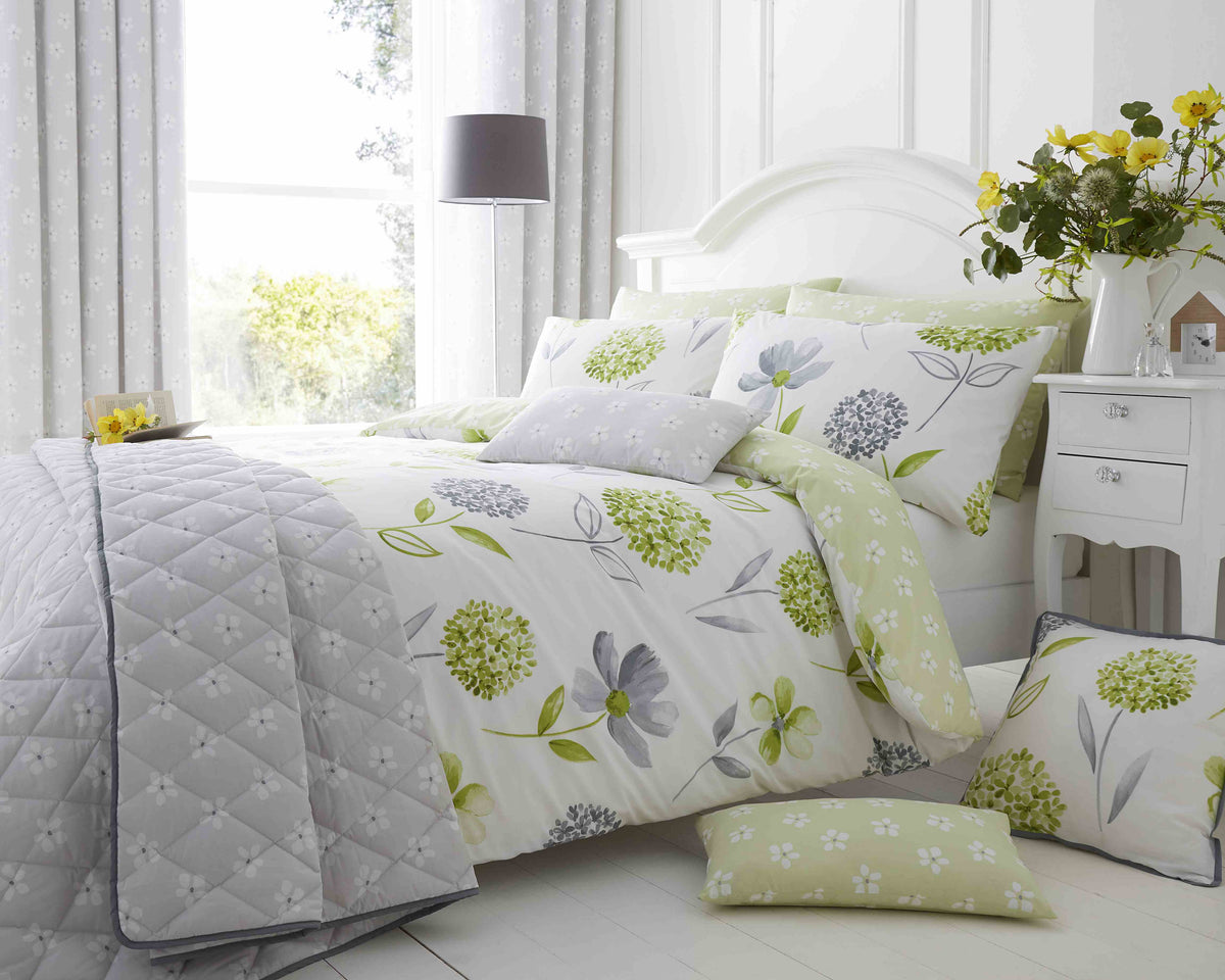 Green Caroline Floral 200 Thread Count Cotton-Rich Duvet Set from Bellissimo Home on a king bed with matching pillow shams.