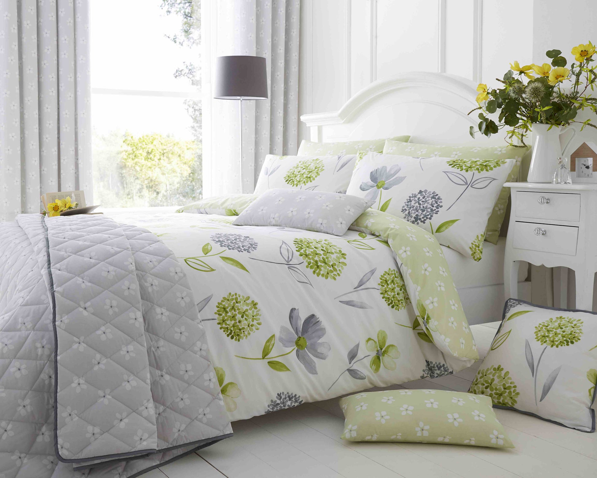 Green Caroline Floral 200 Thread Count Cotton-Rich Duvet Set from Bellissimo Home on a king bed with matching pillow shams.