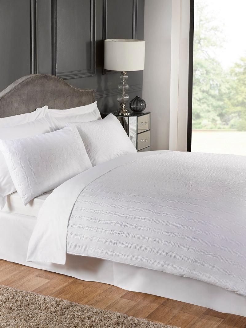 White polycotton duvet cover set from Bellissimo Home with matching pillowcases on a single bed.