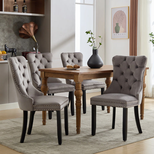 Set of 4 beige modern velvet dining chairs with button tufted design and wooden legs, stylish and comfortable for dining rooms.