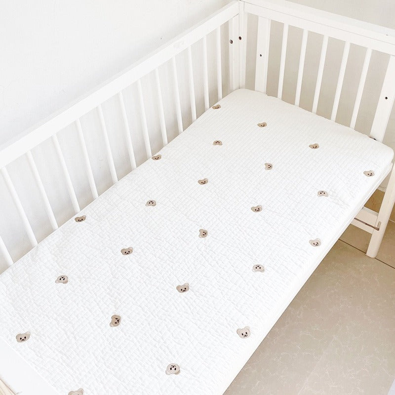 Baby fitted sheet by eprolo with quilted cotton fabric and embroidered bear head design, suitable for crib bedding.