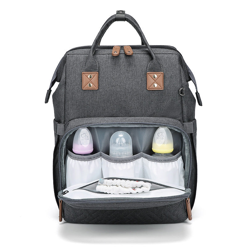 HOMCOM multifunctional portable folding crib mommy bag with compartments, fabric material, and compact design for easy transport.