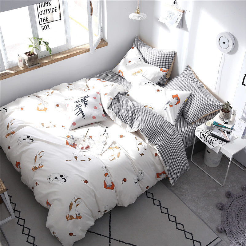 Grey HOMCOM four-piece cotton bedding set with pillowcases and duvet cover laid out on a bed.