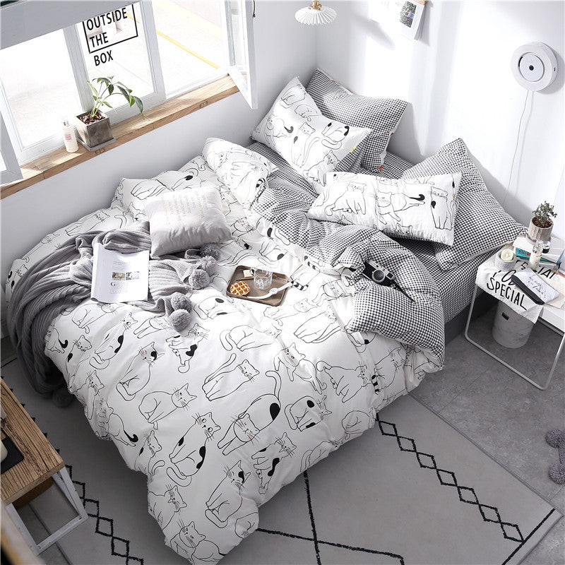 Grey four-piece cotton bedding set from HOMCOM with matching pillowcases and duvet cover, soft and comfortable for bedroom.