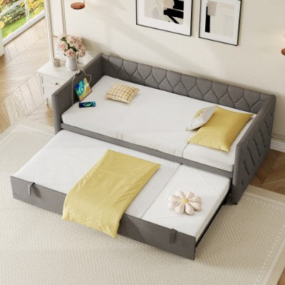Grey linen upholstered daybed with pull-out trundle and built-in USB charging station, perfect for guest rooms and lounging.
