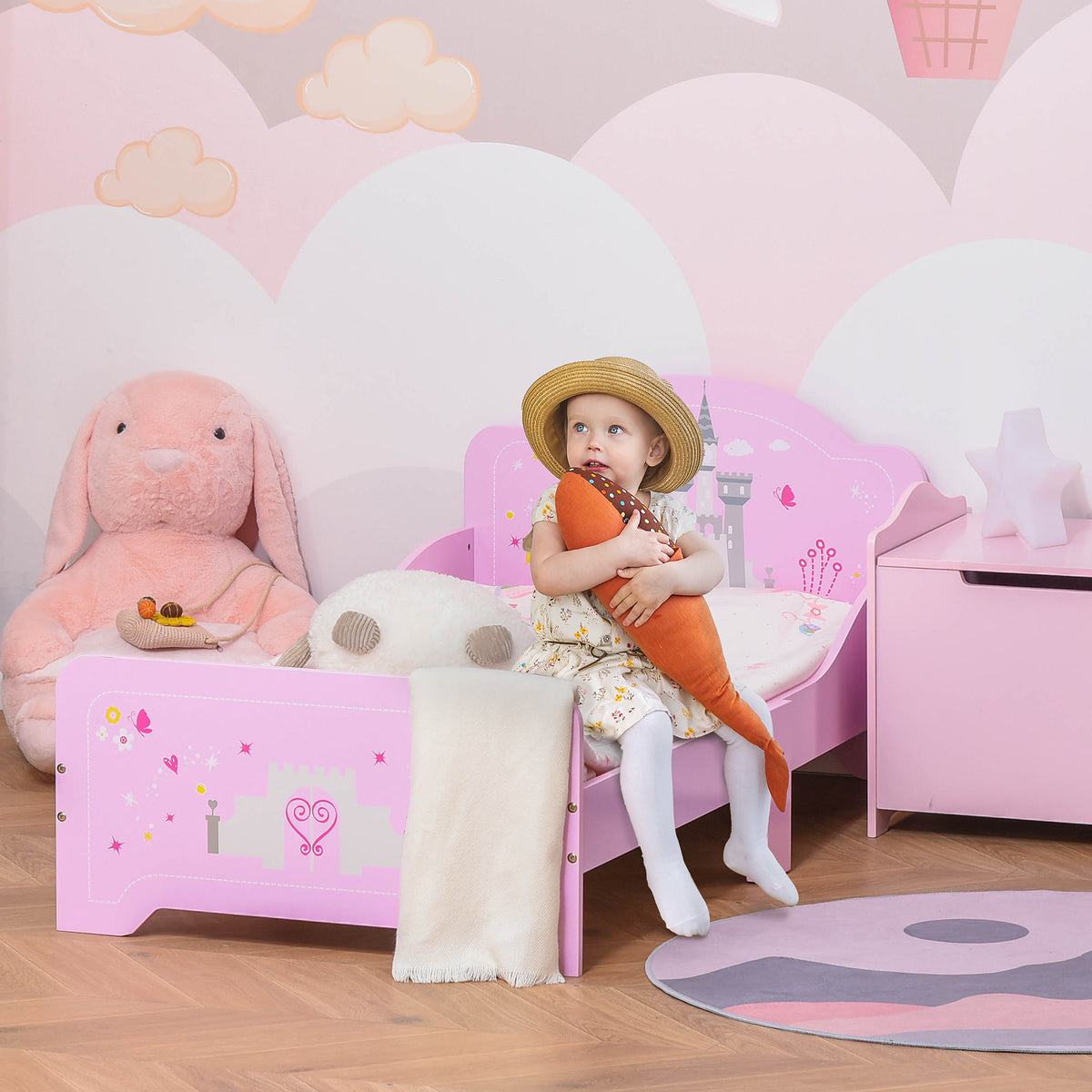 Pink kids bed with princess castle theme, side rails, and slats for ages 3-6, featuring HOMCOM branding and colorful design.