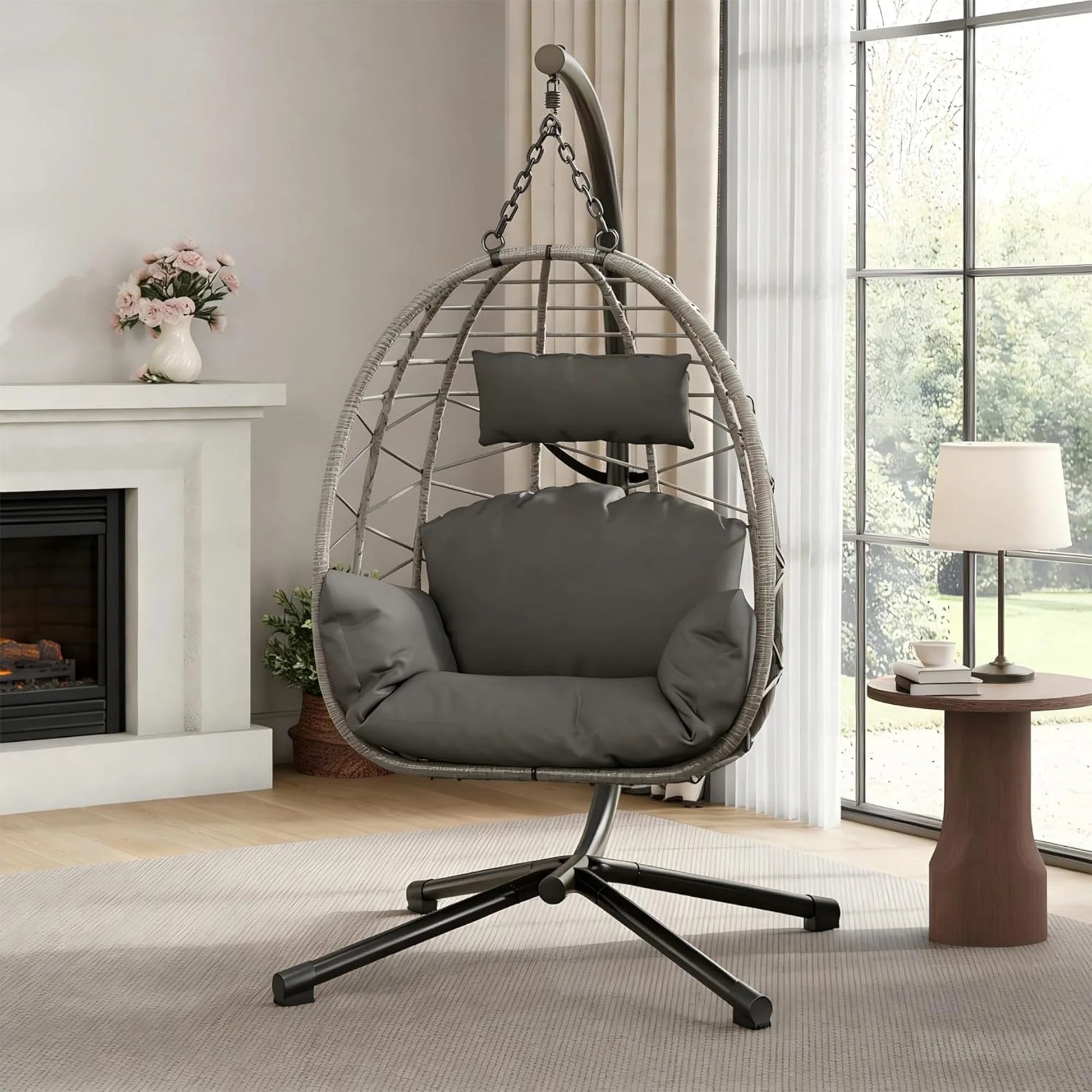 Beige foldable rattan swing egg chair with metal stand, suitable for indoor or outdoor patio and garden use.