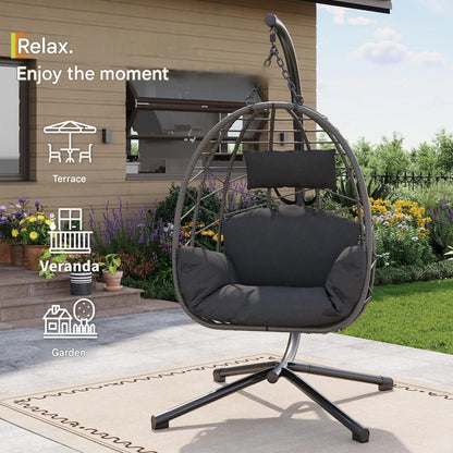 Beige foldable rattan egg chair with metal stand, suitable for indoor or outdoor use, weatherproof patio garden furniture.