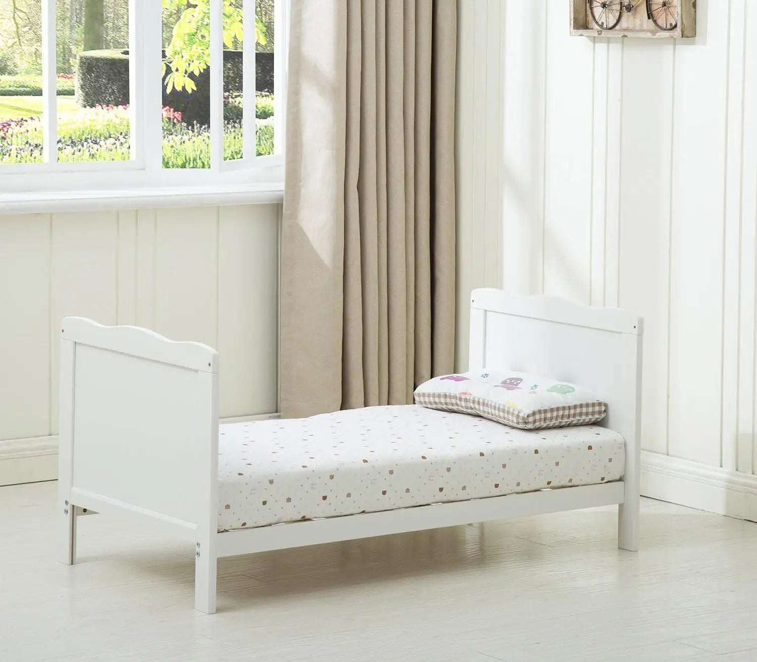 Grey wooden baby cot bed Orlando by Livoshop with top changer and aloe vera water-repellent mattress in a nursery setting.