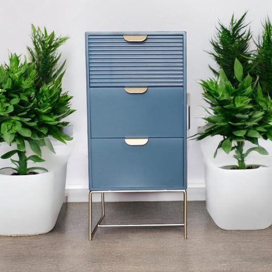 Blue wooden bedside table with three drawers and scalloped design, featuring a stylish storage unit by MSL.