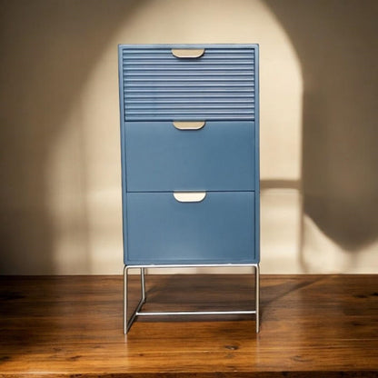 Blue wooden bedside table by MSL with three drawers and scalloped design, ideal for stylish bedroom storage.