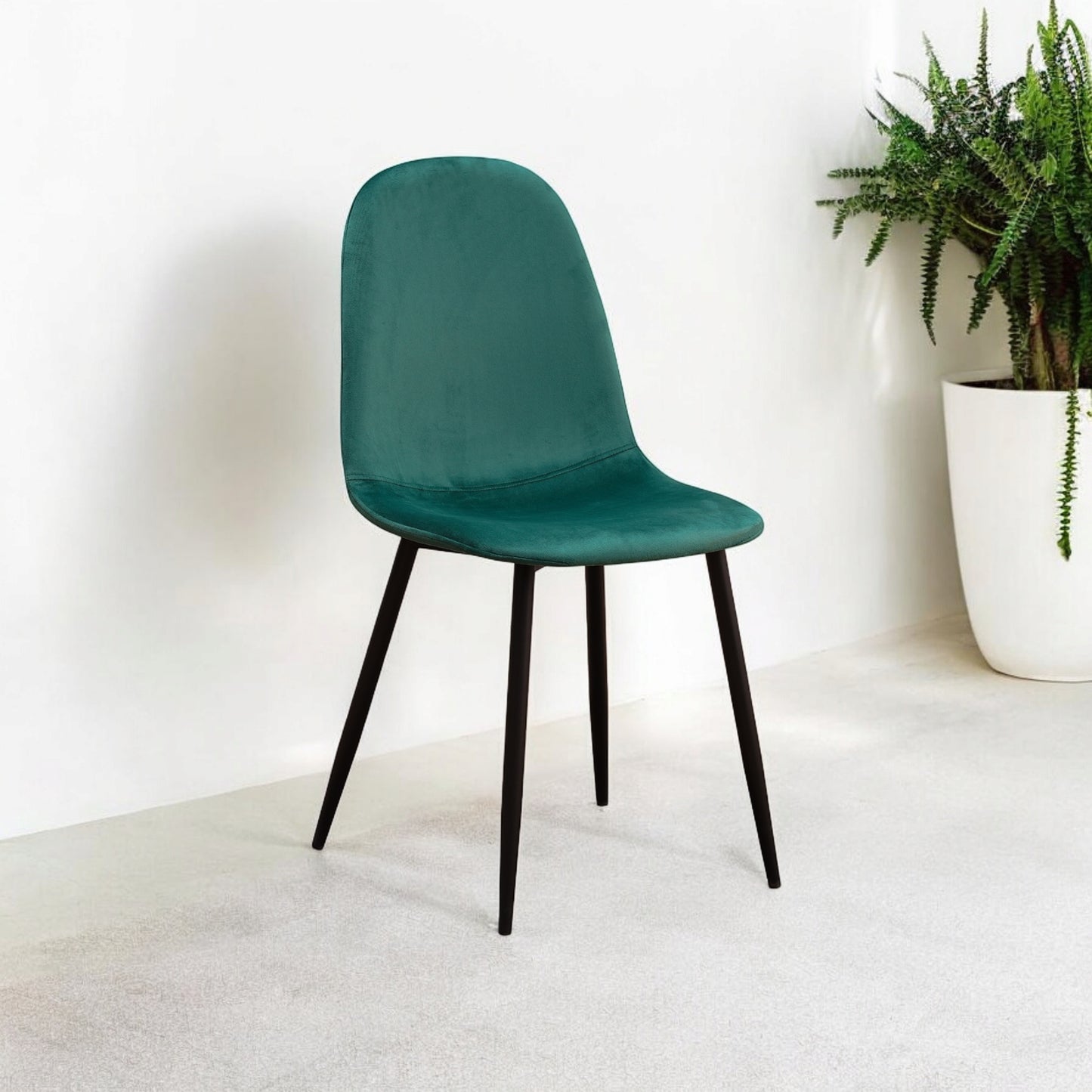 Green fabric chair with black metal legs, modern design, and cushioned seat for comfortable seating.