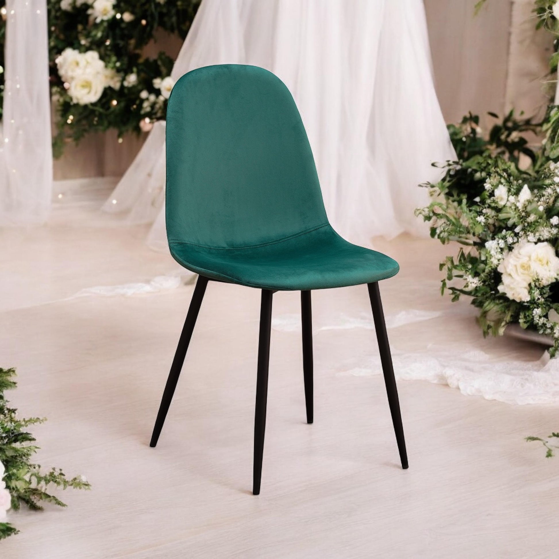 Green fabric chair with black metal legs by MSL, showcasing a modern, comfortable seating design with stylish metal accents.