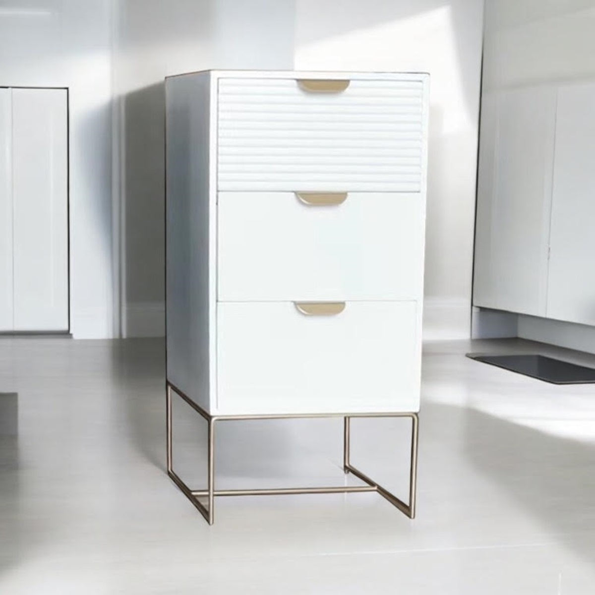 White wooden bedside table with three scalloped drawers, compact storage unit by MSL for bedroom organization.