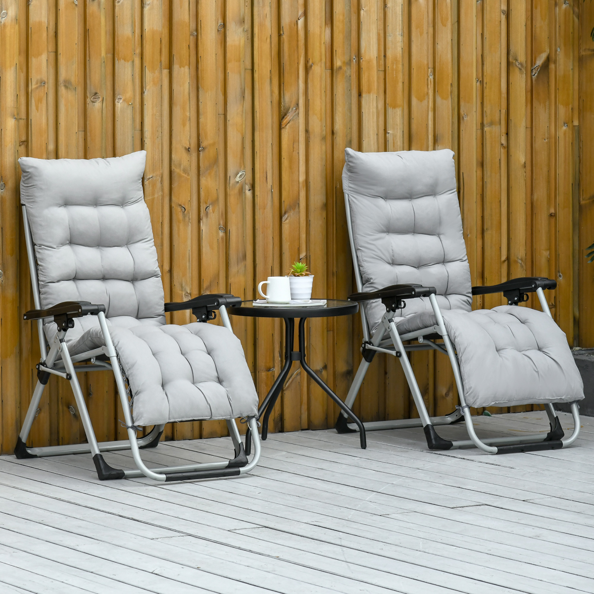 Two light grey Outsunny zero gravity recliner chairs with folding lounger cushions for outdoor relaxation.