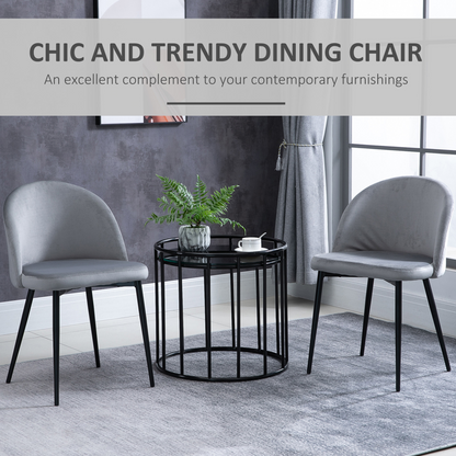 Two modern upholstered fabric bucket seat dining chairs in grey, designed for contemporary kitchen or dining room decor.