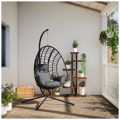 Beige hanging egg chair with steel stand, anthracite rattan design, comfortable seating and modern outdoor furniture style.
