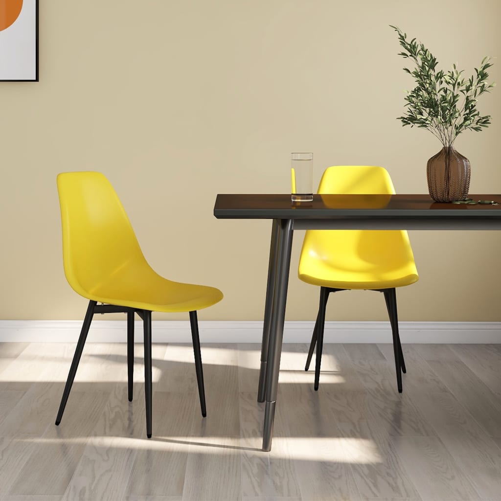 Two white vidaXL dining chairs with PP seats and backs, modern design, shown from a side angle on a dining room floor