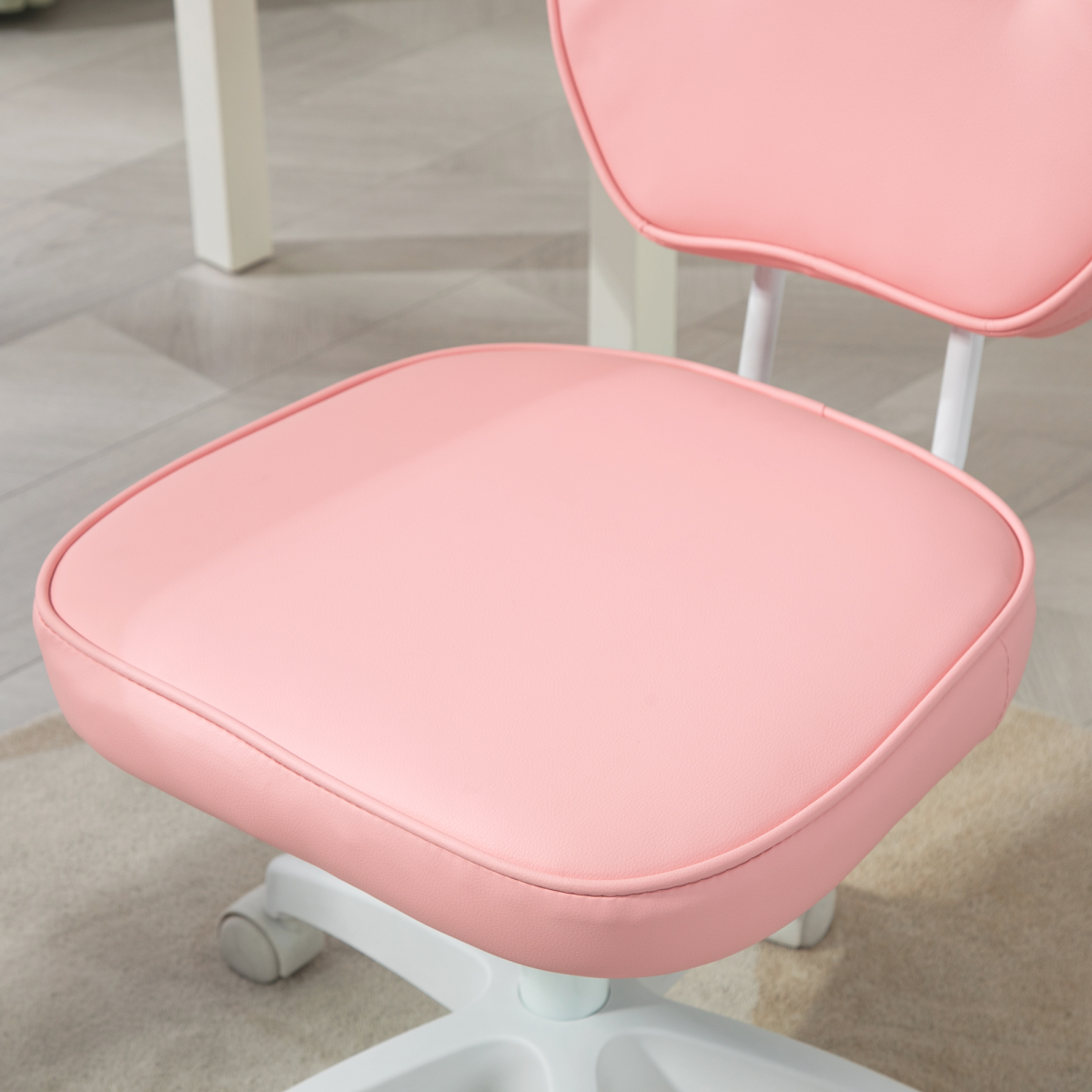Pink PU leather kids swivel desk chair with adjustable height and ergonomic design, ideal for study and play.